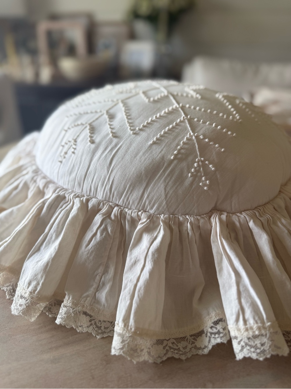 Handmade white candlewicking starburst pillow with ruffled lace trim.